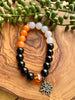 Black, White & Orange Beaded Stretch Bracelet w/ Adinkra Charm